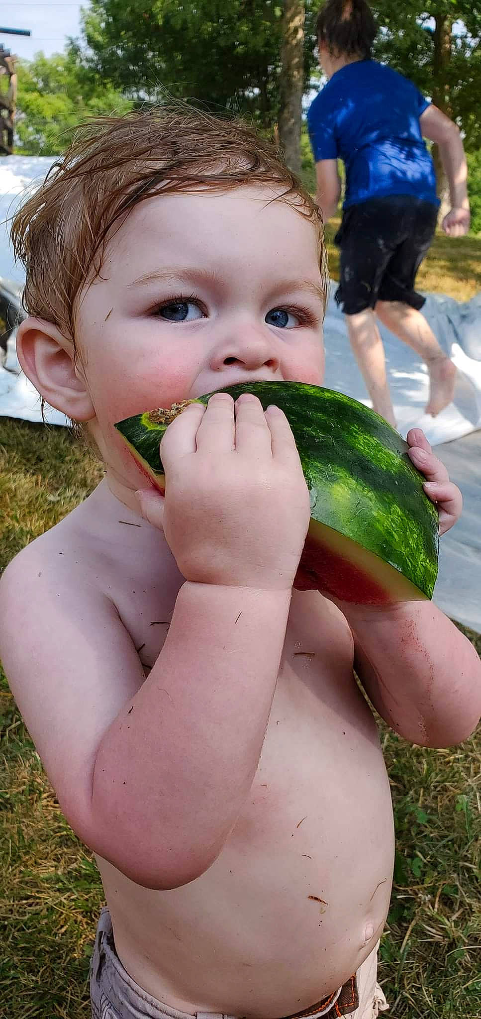 Tucker joined the competition — help win amazing prizes! child, cucumis, eye, face, finger, fruit, gesture, grass, hand, happy, head, leisure, lip, mouth, natural_foods, nose, people_in_nature, person, plant, shorts