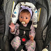 Anaria joined the competition — help win amazing prizes! baby, baby_clothes, car_seat, child, comfort, cute, floral_pattern, headband, indoors, infant, newborn, pacifier, person, portrait, purple_onesie, resting, safety_harness, seat, straps, young_child