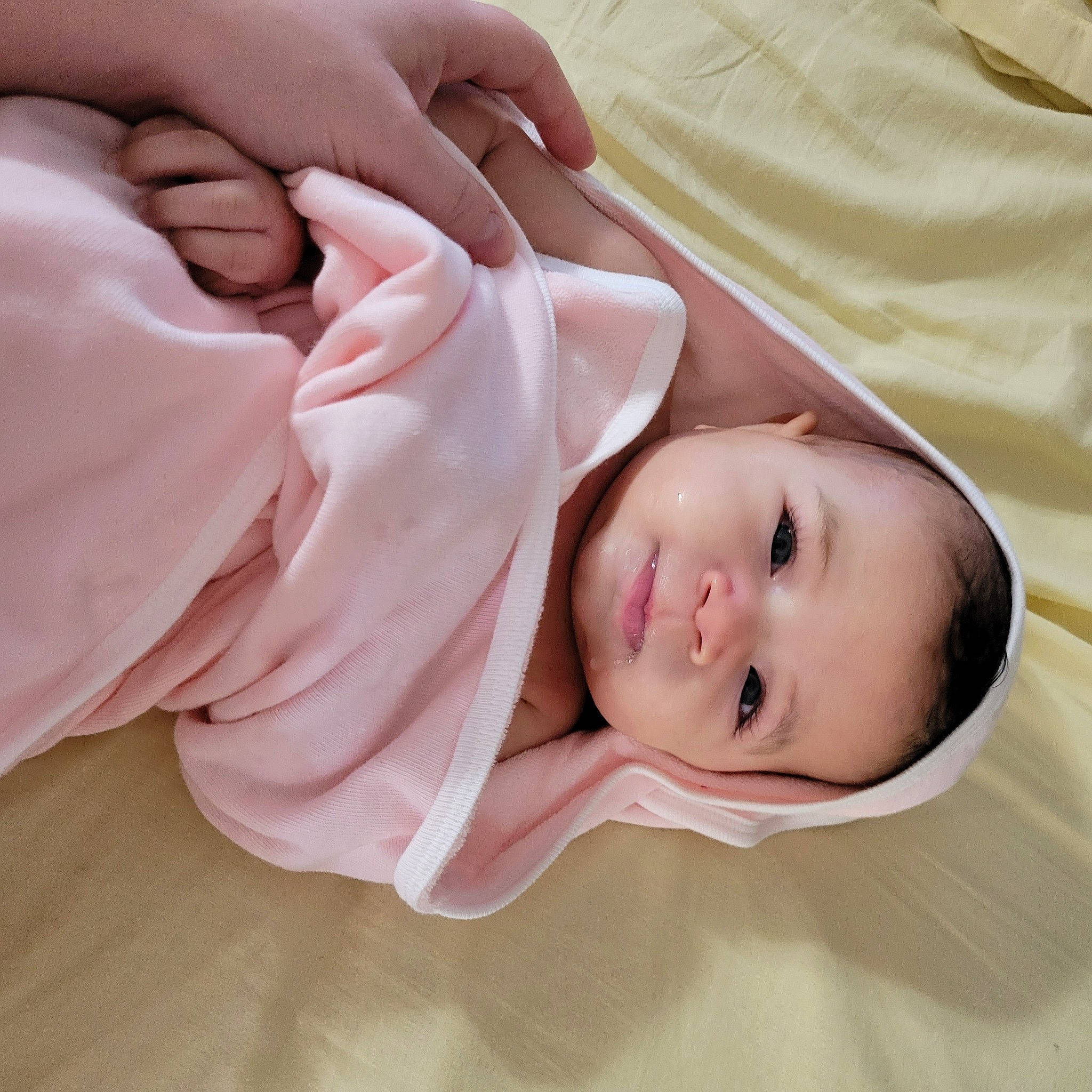 Reina is registered to the contest to win money with this photo: baby, baby_toddler_clothing, cheek, child, comfort, eyelash, finger, gesture, happy, linens, lip, nail, nose, person, pink, product, skin, sleeve, thumb, toddler