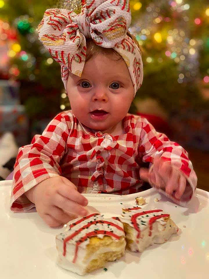 Carmen is registered to the contest to win money with this photo: cake, child, dessert, dish, dress, event, finger_food, food, hair_accessory, happy, head, headpiece, headwear, ingredient, person, plate, recipe, sandwich, sweetness, table