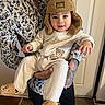 Adnan is registered to the contest to win money with this photo: baby, infant, child, toddler, smiling, portrait, indoor, parent, father, beard, tattoo, bear_hat, teddy_bear, onesie, matching_outfit, being_held, family, door, wooden_floor, cute