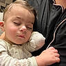 Adnan is registered to the contest to win money with this photo: baby, sleeping, child, infant, portrait, close_up, face, eyes_closed, peaceful, cozy, arms, pajamas, stars, clothing, cuddling, indoors, person, soft_lighting, resting, family
