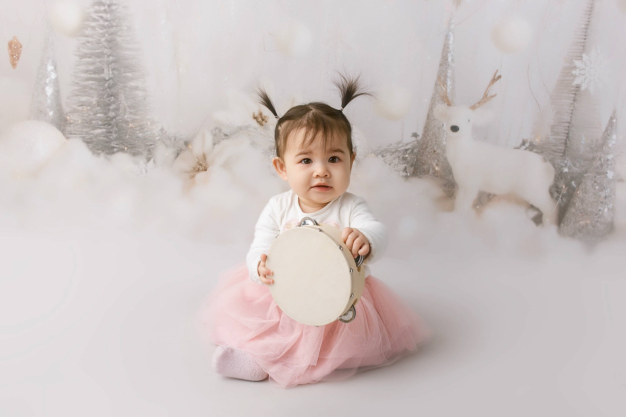 Indie is registered to the contest to win money with this photo: baby, baby_toddler_clothing, child, deer, event, flash_photography, freezing, fun, fur, happy, person, pink, playing_in_the_snow, portrait, portrait_photography, rabbit, recreation, sitting, smile, toddler