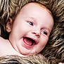 baby, smiling, happy, face, portrait, child, infant, fur, blanket, skin, closeup, cute, young, expression, mouth, cheeks, eyes, head, furry, soft