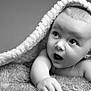 Isabella is registered to the contest to win money with this photo: baby, blanket, black_and_white, cute, expression, face, fur, infant, looking_up, monochrome, newborn, person, portrait, skin, soft, texture, toddler, under_blanket, wide_eyes, young_child