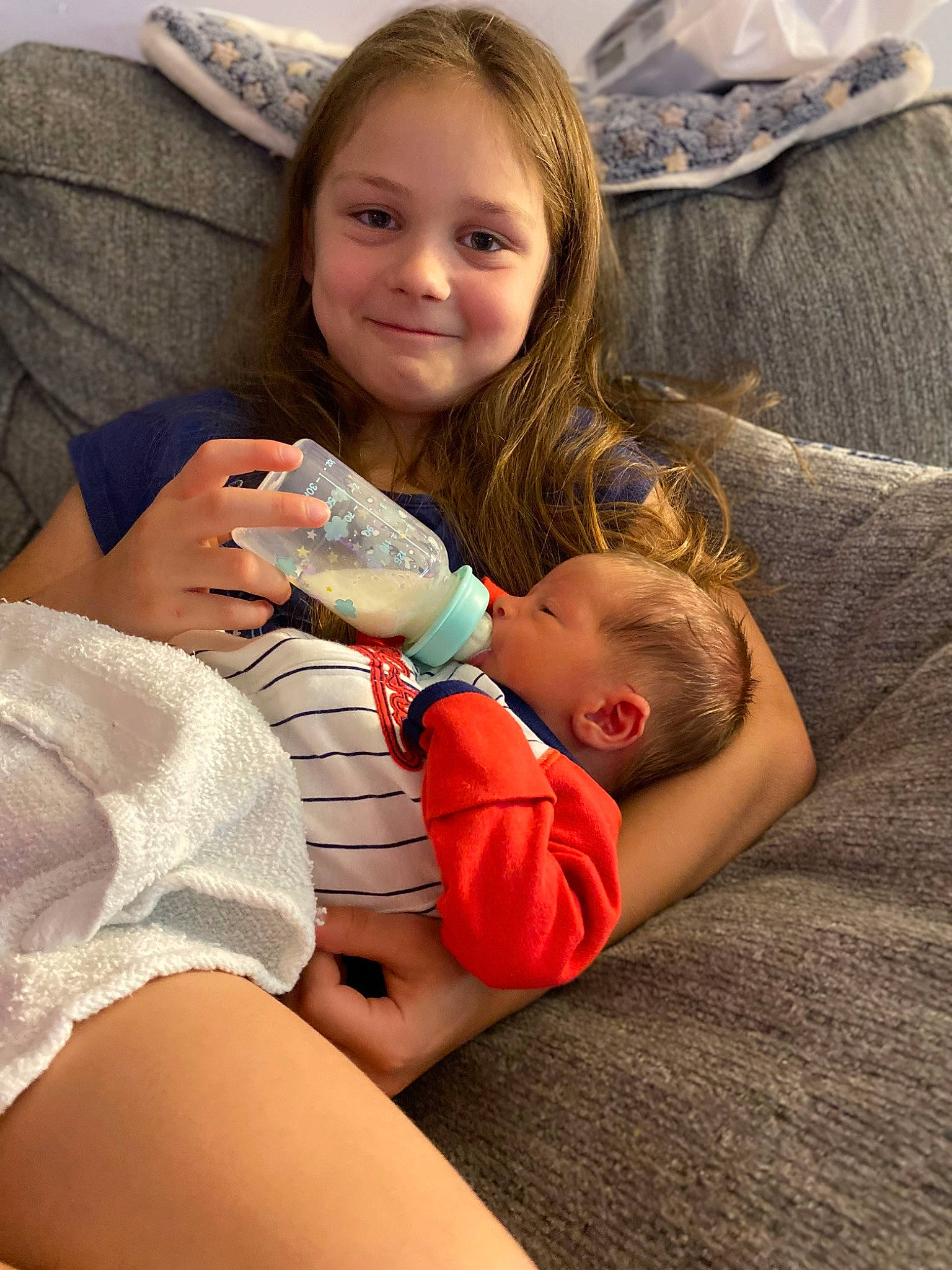 Ariah joined the competition — help win amazing prizes! arm, baby, child, comfort, eye, face, finger, gesture, hairstyle, hand, happy, head, human_body, interaction, joy, lap, leg, person, skin, smile