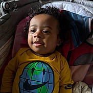 Djulïyan participe au concours pour gagner de l'argent avec cette photo : baby, blanket, child, clothing, cozy, curly_hair, cushion, cute, face, happy, indoor, infant, nike_logo, portrait, relaxed, seat, smile, soft_light, toddler, yellow_shirt