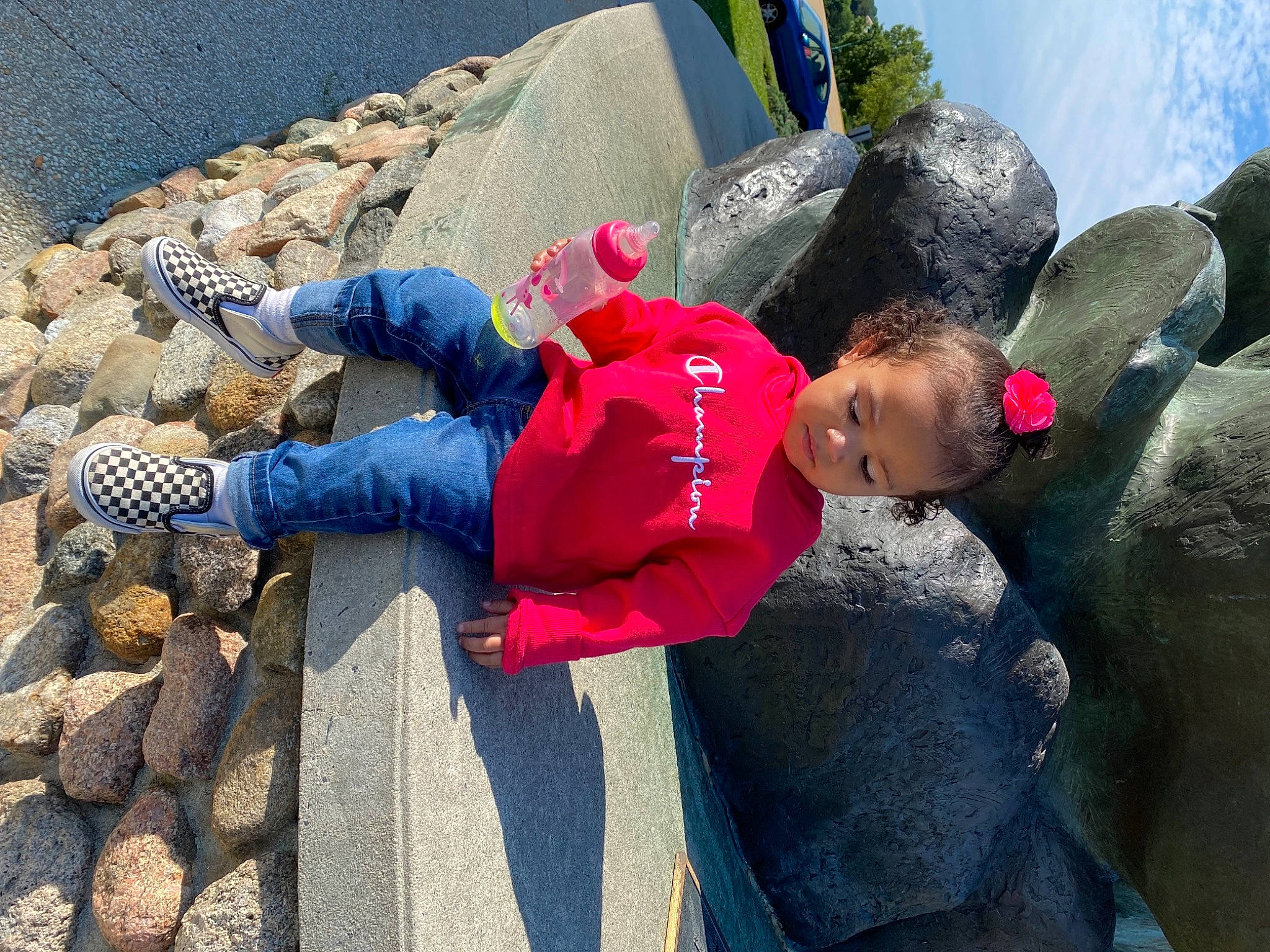 Delilah joined the competition — help win amazing prizes! blue, child, denim, fun, human, landscape, leisure, person, play, recreation, rock, sandal, sitting, toddler, tourism, travel, tree, vacation, water, winter