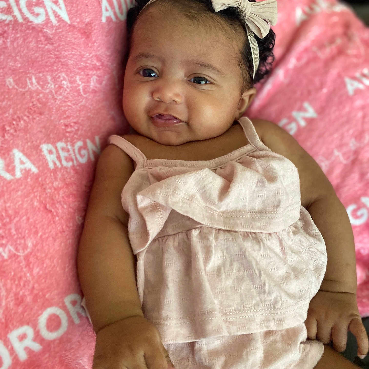 Aurora is registered to the contest to win money with this photo: accessories, baby, clothing, cushion, dress, face, furniture, happy, head, homedecor, jewelry, newborn, person, photography, portrait, quilt, sitting, sleeping, smile, t_shirt