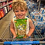 Flynn joined the competition — help win amazing prizes! child, boy, shopping_cart, store, grocery_store, snack, peanuts, bag, smiling, blonde_hair, shorts, aisle, products, water_bottles, retail, happy, casual_clothing, supermarket, indoor, shopping