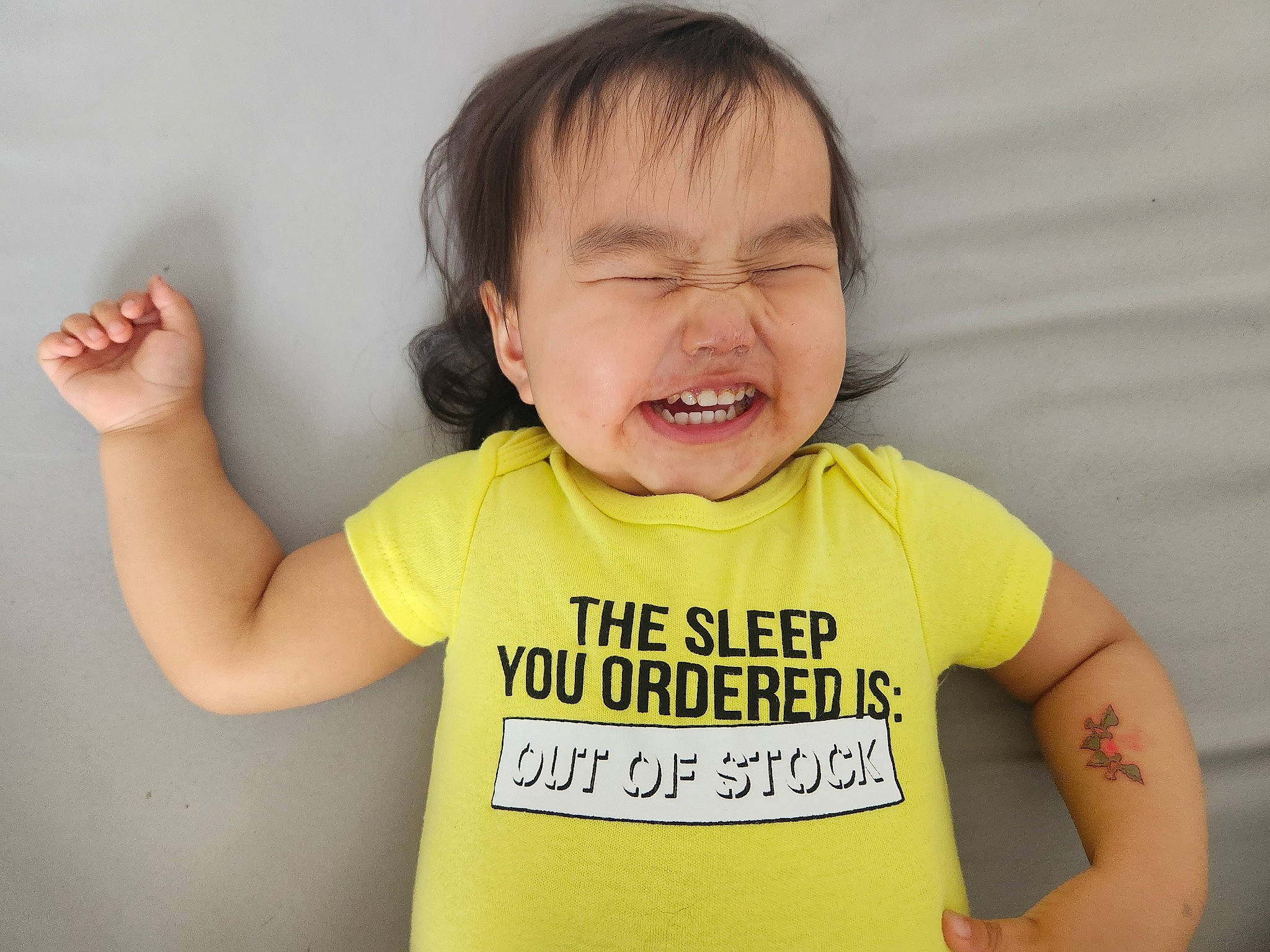 Breanna is registered to the contest to win money with this photo: arm, baby, baby_toddler_clothing, cheek, child, ear, eye, eyelash, facial_expression, finger, fun, gesture, happy, head, nose, person, skin, sleeve, sorrow, t_shirt