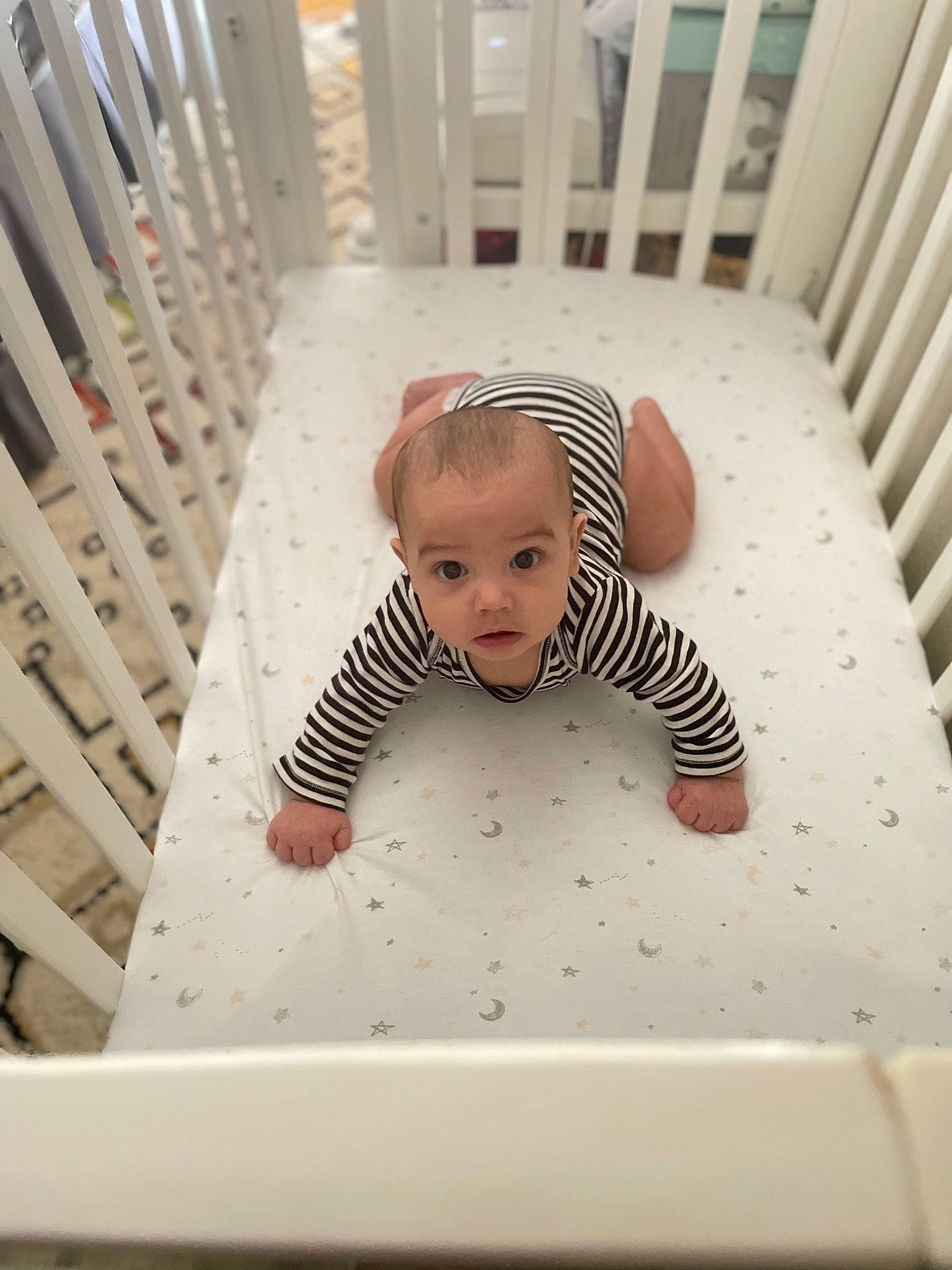 Lennon is registered to the contest to win money with this photo: baby, baby_products, baby_safety, baby_toddler_clothing, child, comfort, cradle, crawling, eye, floor, flooring, hardwood, human_body, infant_bed, linens, pattern, person, sleeve, t_shirt, toddler