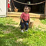barn, casual_clothing, child, curly_hair, daylight, grass, happy, nature, navy_pants, outdoor, pink_top, playful, portrait, smile, standing, sunlight, toddler, white_shoes, wooden_stump, young_child