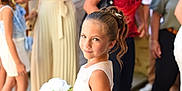 Lola participe au concours pour gagner de l'argent avec cette photo : child, girl, flower_bouquet, white_dress, hair_accessory, smile, portrait, event, formal_clothing, people, crowd, blurred_background, standing, happy, outdoor, celebration, fashion, person, young, cute
