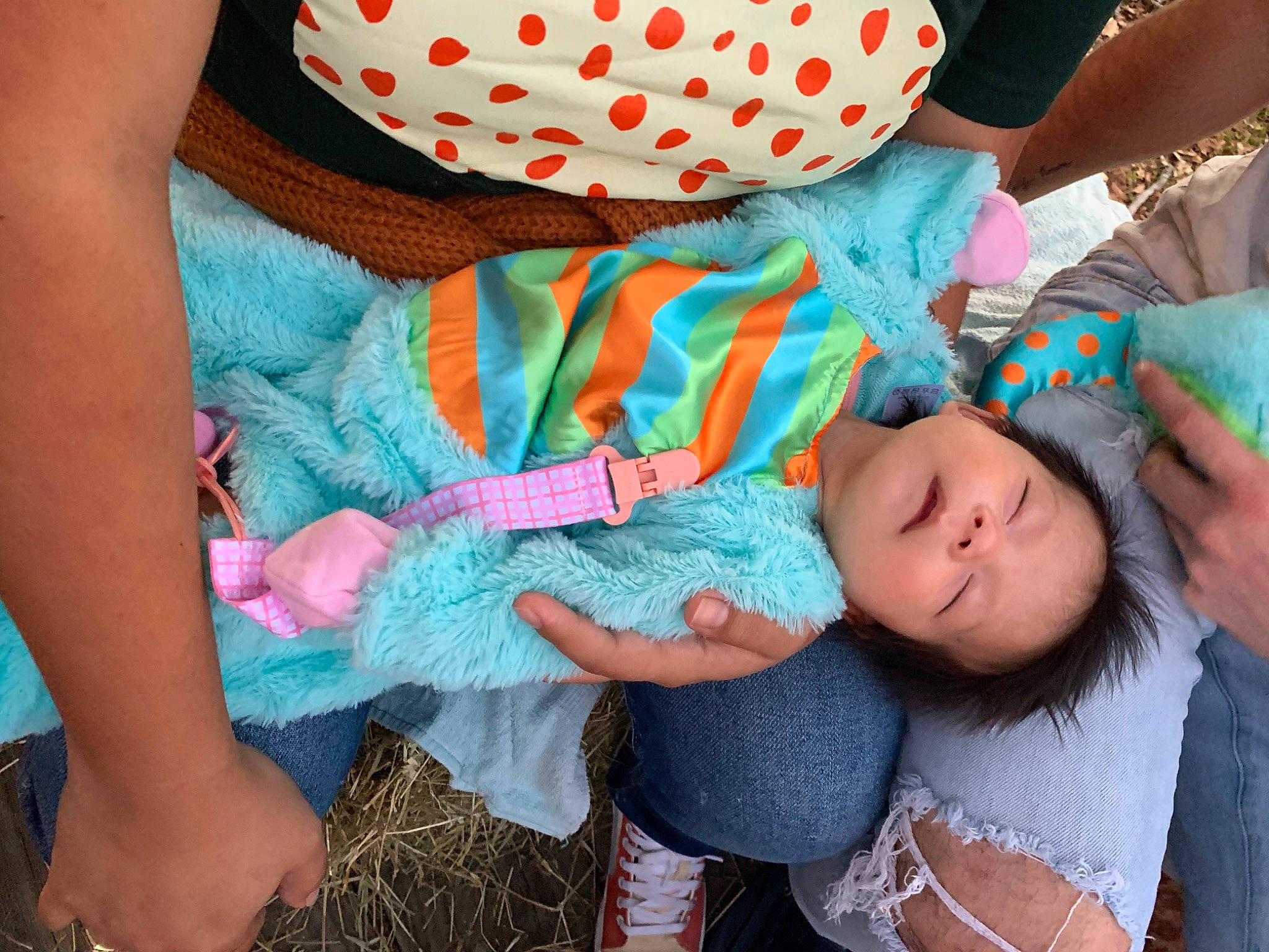 Angela is registered to the contest to win money with this photo: baby, baby_toddler_clothing, child, comfort, eye, finger, fun, gesture, grass, green, hand, happy, interaction, nail, pattern, people, person, pink, skin, thigh