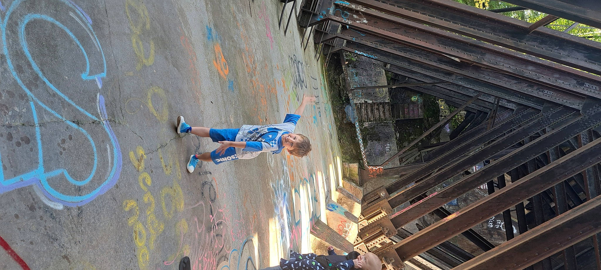 Joseph James is registered to the contest to win money with this photo: adventure, city, concrete, electric_blue, extreme_sport, facade, fun, handrail, joy, leisure, metal, pedestrian, person, recreation, shadow, sidewalk, stairs, street, t_shirt, tree