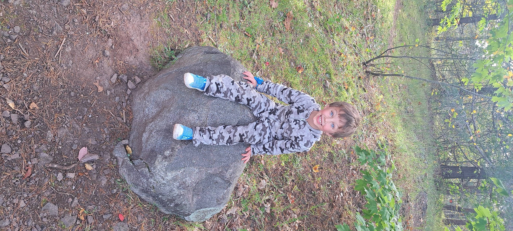 Joseph James is registered to the contest to win money with this photo: asphalt, concrete, forest, fun, grass, groundcover, joy, landscape, leaf, leisure, pattern, people_in_nature, person, plant, road_surface, rock, shadow, shrub, sitting, soil