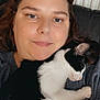 Milkshake is registered to the contest to win money with this photo: black_and_white_cat, casual_clothing, cat, close_up, comfort, couch, cozy, face, fur, home, human, indoor, person, pet, radiator, relaxed, resting, sleeping_cat, smile, snuggling