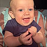 baby, blue_eyes, child, clapping, cushion, cute, face, hand, happy, indoor, infant, light, onesie, person, portrait, sitting, skin, smiling, striped, young