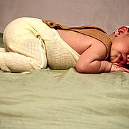 Daxton is registered to the contest to win money with this photo: baby, blanket, child, cozy, cute, face, hand, hat, infant, knitwear, laying_down, newborn, peaceful, portrait, resting, skin, sleeping, small, soft, warm