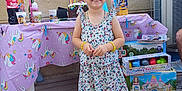Lou-ann a rejoint le concours — aidez-le/la à gagner de superbes lots ! child, girl, smiling, dress, pink_sandals, birthday, cake, candles, balloons, table, unicorn_tablecloth, wooden_deck, party, toys, beads, bracelets, outdoor, celebration, window, bottle