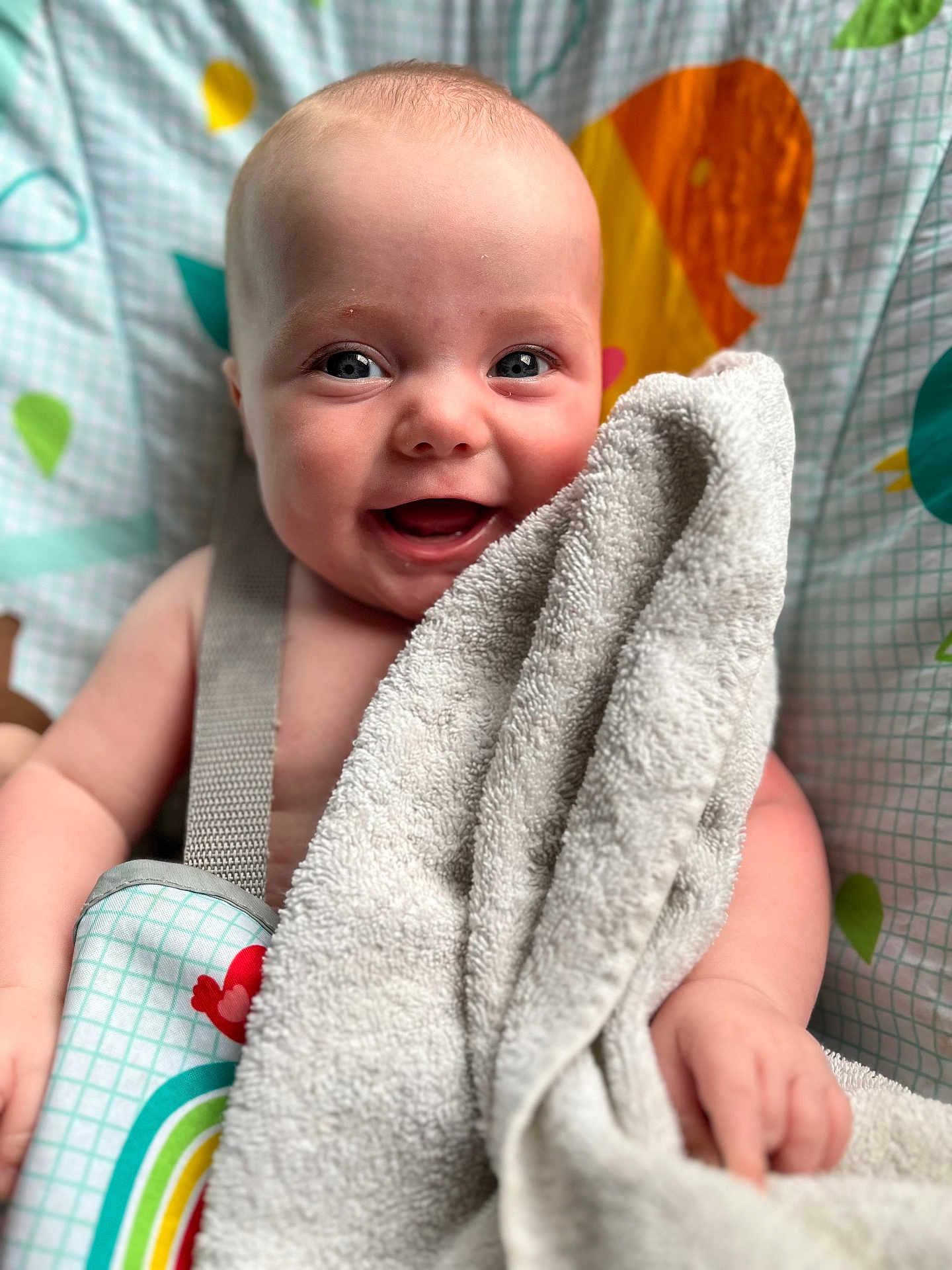 Ava joined the competition — help win amazing prizes! baby, towel, smile, happy, face, child, blanket, pattern, colorful, infant, cute, skin, hand, seatbelt, fabric, playful, closeup, portrait, indoor, soft