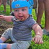 baby, helmet, grass, dirt, smiling, outdoor, child, person, blue_helmet, casual_clothing, sunlight, toy_wheel, happy, nature, playtime, legs, adult, greenery, daylight, fun
