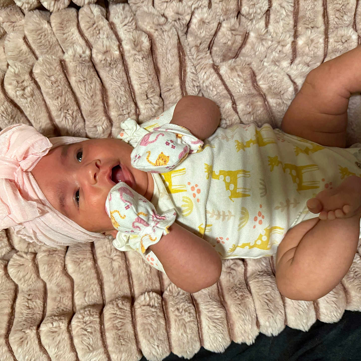 Jayleen is registered to the contest to win money with this photo: animal_print, apparel, baby, blanket, child, cozy, cute, giraffe_print, happy, headwrap, indoor, infant, lying_down, mittens, newborn, onesie, pink, portrait, soft_texture, yellow