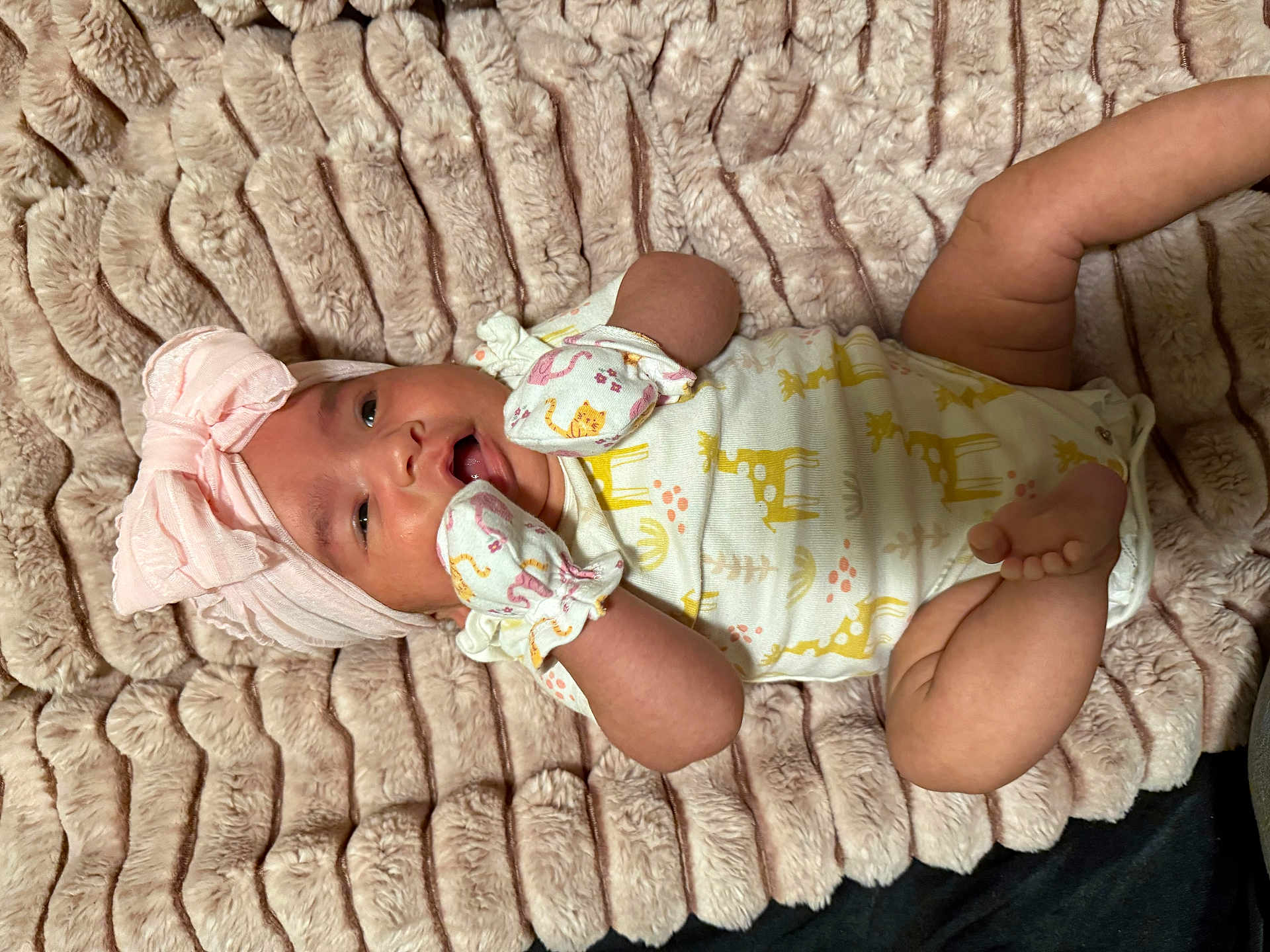 Jayleen is registered to the contest to win money with this photo: baby, infant, blanket, headwrap, mittens, onesie, giraffe_print, pink, yellow, cute, soft_texture, lying_down, child, newborn, happy, cozy, portrait, apparel, animal_print, indoor