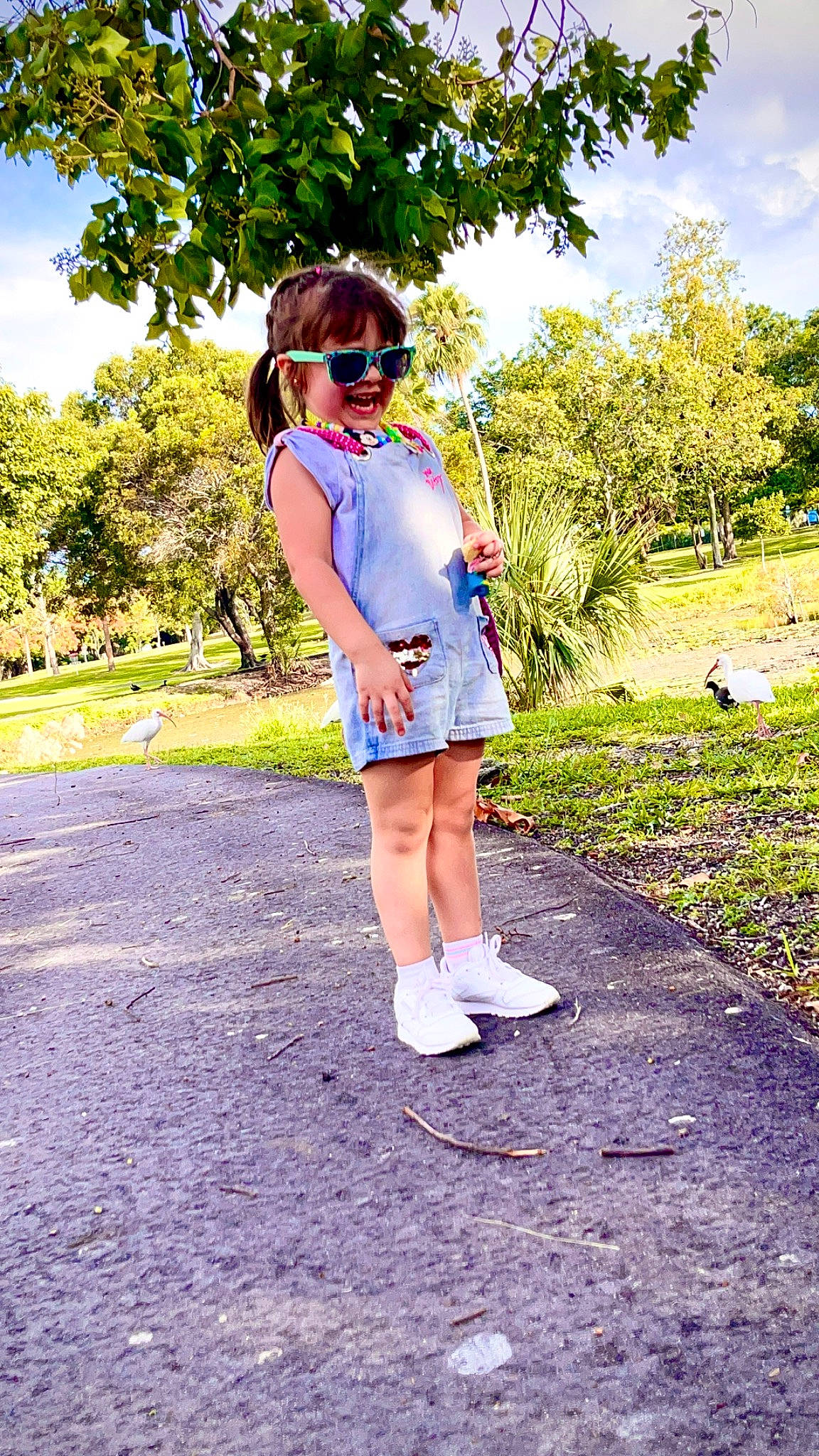 Valeria Victoria joined the competition — help win amazing prizes! asphalt, denim, electric_blue, eyewear, grass, grassland, happy, human_leg, leisure, magenta, people_in_nature, person, plant, recreation, sky, sleeve, sunglasses, t_shirt, toddler, tree