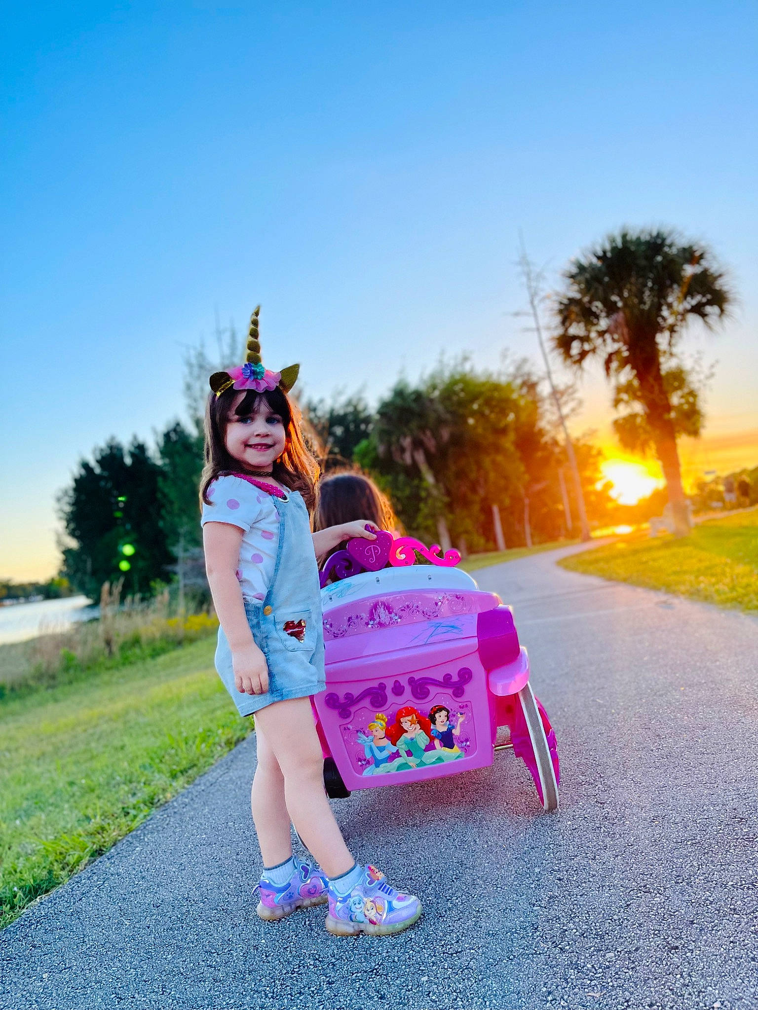 Victoria is registered to the contest to win money with this photo: asphalt, child, electric_blue, eyewear, fun, grass, happy, joy, landscape, leisure, magenta, people_in_nature, person, plant, recreation, road, sky, toddler, tourism, travel