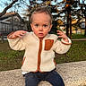 toddler, child, park, bench, jacket, boots, pants, outdoor, trees, grass, sunlight, fall, expression, face, person, young_child, nature, daytime, casual_clothing, curious