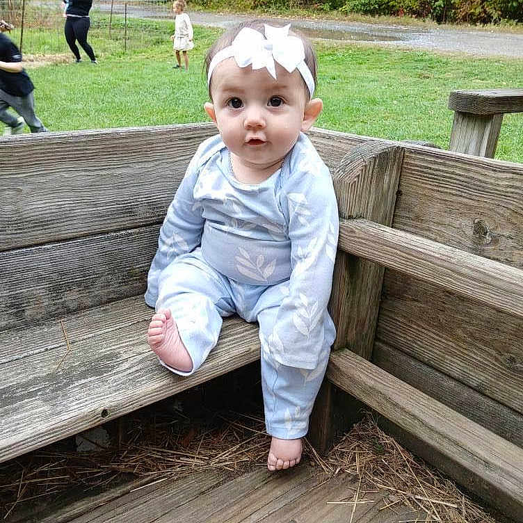 Neytiri Jarvis is registered to the contest to win money with this photo: baby, bench, clothing, crawling, face, furniture, grass, head, jeans, nature, outdoors, pants, park, people, person, photography, plant, portrait, sitting, wood