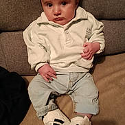 Livio a rejoint le concours — aidez-le/la à gagner de superbes lots ! baby, child, person, sitting, indoor, couch, clothing, sweater, jeans, shoes, footwear, cute, expression, portrait, young_child, home, furniture, casual, fashion, face