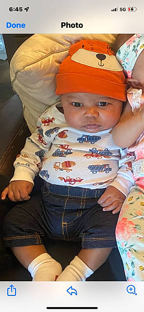 Hakeem joined the competition — help win amazing prizes! baby, baby_toddler_clothing, baseball_cap, cap, cheek, child, cool, fashion_accessory, fun, happy, headwear, human_leg, mouth, orange, person, pink, sitting, skin, sleeve, t_shirt
