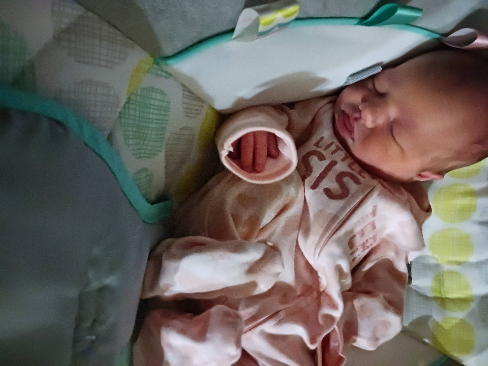 Kya is registered to the contest to win money with this photo: baby, baby_products, baby_toddler_clothing, baseball_cap, cap, cheek, child, comfort, drinkware, face, happy, linens, pattern, person, room, smile, toddler