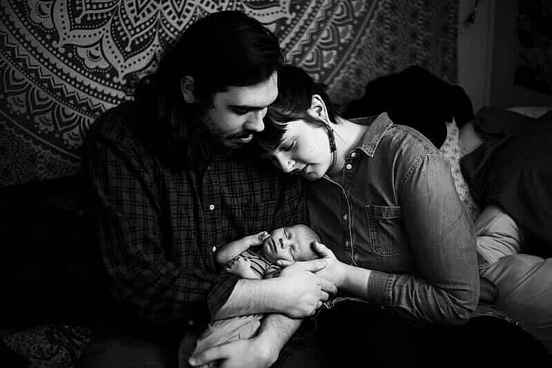 Evander is registered to the contest to win money with this photo: beard, black_and_white, black_hair, comfort, darkness, elbow, event, eyewear, flash_photography, fun, gesture, glasses, hand, happy, monochrome, monochrome_photography, person, room, sitting, smile