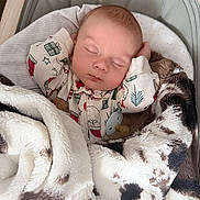 Briggs is registered to the contest to win money with this photo: baby, sleeping, blanket, onesie, pacifier, infant, cozy, cute, bed, resting, child, soft, warm, holiday, pattern, face, peaceful, cute_baby, indoors, comfort
