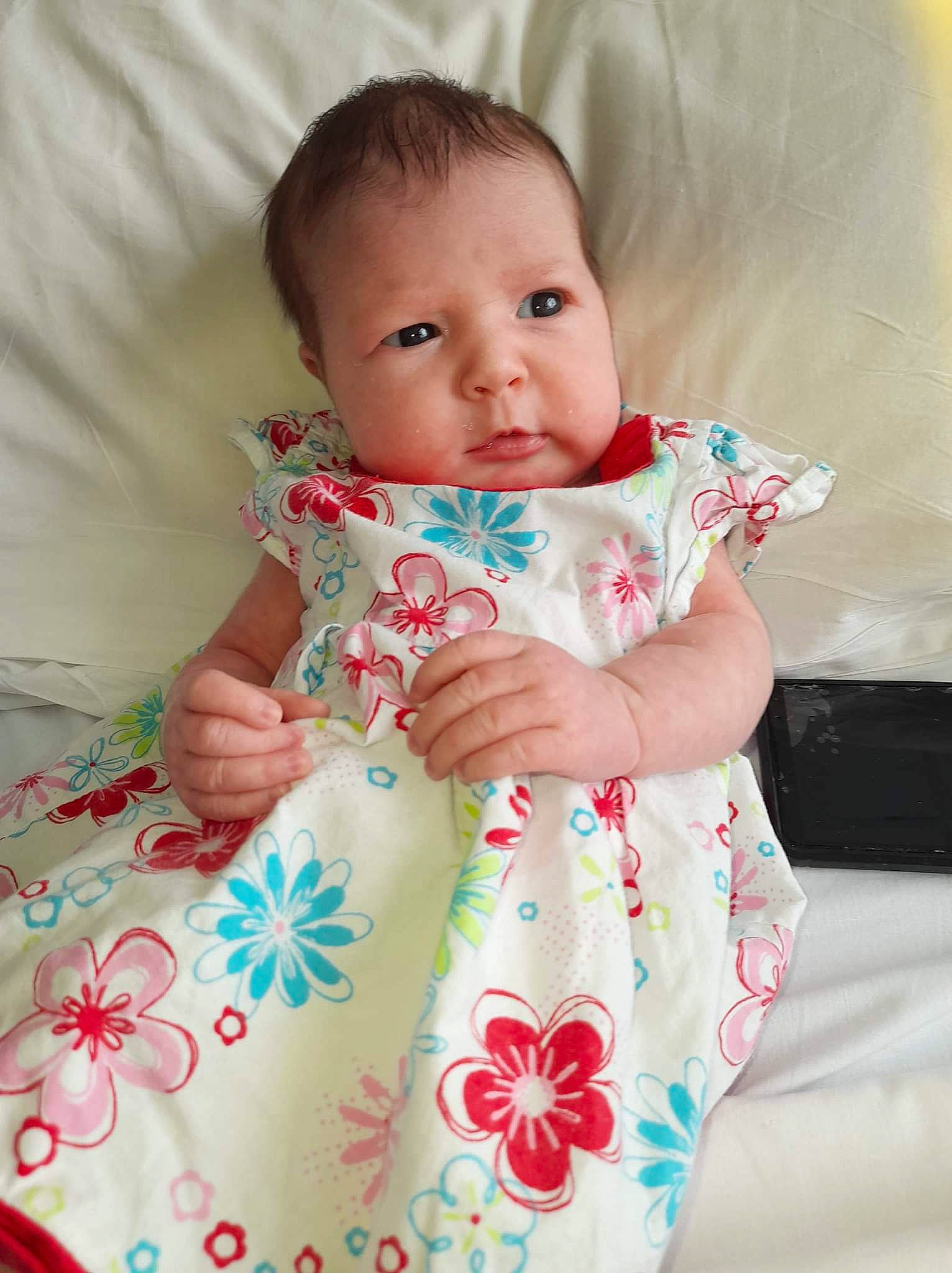 Liliana is registered to the contest to win money with this photo: arm, baby, baby_toddler_clothing, cheek, collar, dress, eye, face, finger, hand, head, human_body, iris, lip, neck, person, pink, product, skin, sleeve