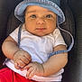 Djanna participe au concours pour gagner de l'argent avec cette photo : baby, child, denim_hat, white_tshirt, red_shorts, cushioned_seat, cute, chubby_cheeks, hands, face, looking_at_camera, indoors, portrait, infant, casual_clothing, headwear, skin, eyes, expression, comfort
