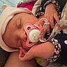 Iris joined the competition — help win amazing prizes! baby, newborn, sleeping, pacifier, hat, blanket, hand, infant, cozy, clothing, cute, resting, closeup, face, soft, pink, patterned, wrapped, peaceful, indoors