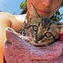 person, kitten, cat, towel, outdoor, selfie, close_up, sunlight, blue_sky, tree, earrings, skin, animal, pet, young_person, face, eyes, nature, daylight, portrait