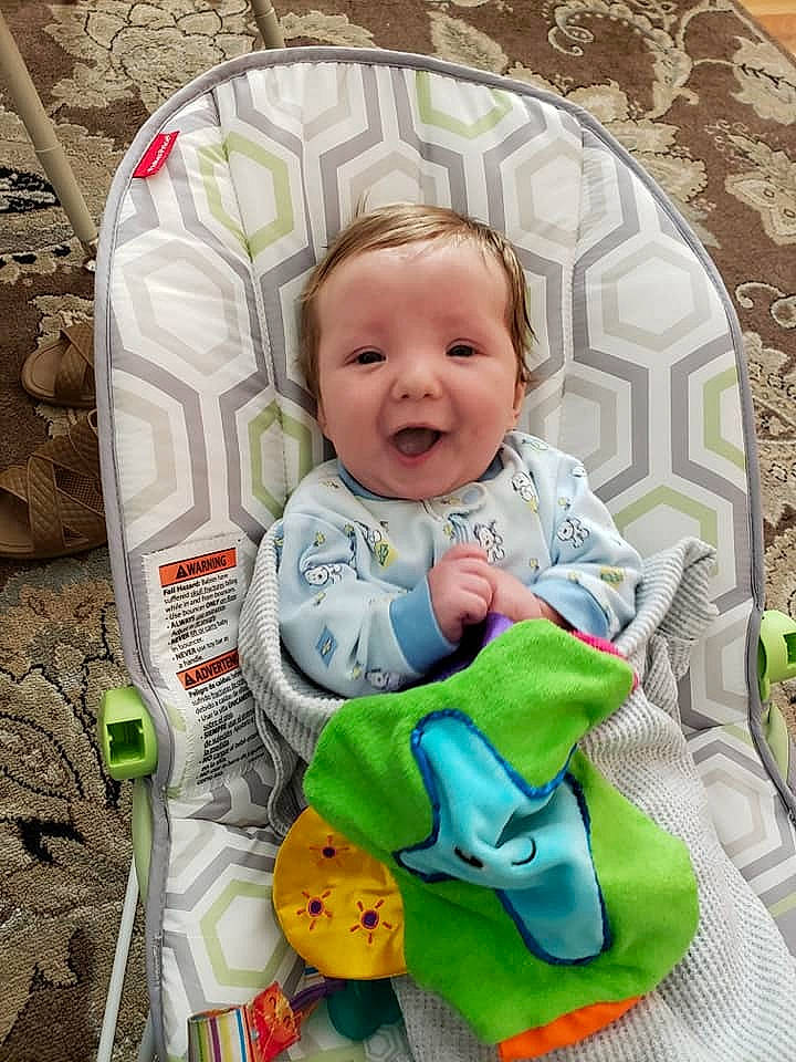 Timothy is registered to the contest to win money with this photo: baby, baby_products, baby_toddler_clothing, baby_toys, cheek, child, comfort, eye, facial_expression, happy, linens, person, play, product, sitting, skin, sleeve, smile, t_shirt, textile
