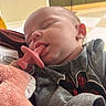 Leia is registered to the contest to win money with this photo: architecture, baby, blanket, bodypart, building, clothing, face, finger, glove, hand, head, knitwear, mouth, newborn, person, photography, portrait, sleeping, sweater, toy