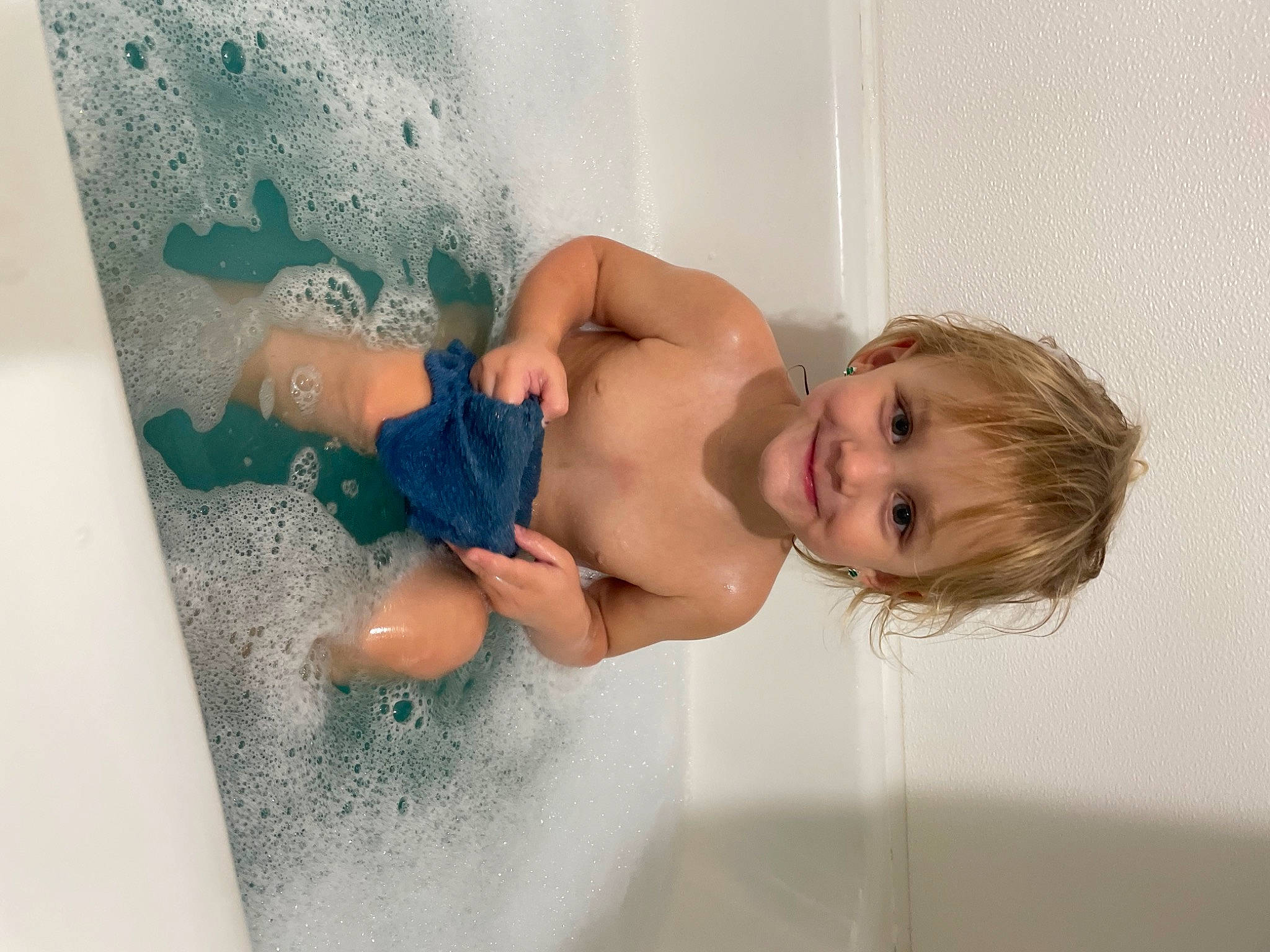 Everley is registered to the contest to win money with this photo: arm, baby, barechested, bathing, cheek, chest, child, foam, fun, hand, happy, human_body, joy, leisure, muscle, person, recreation, smile, stomach, toddler