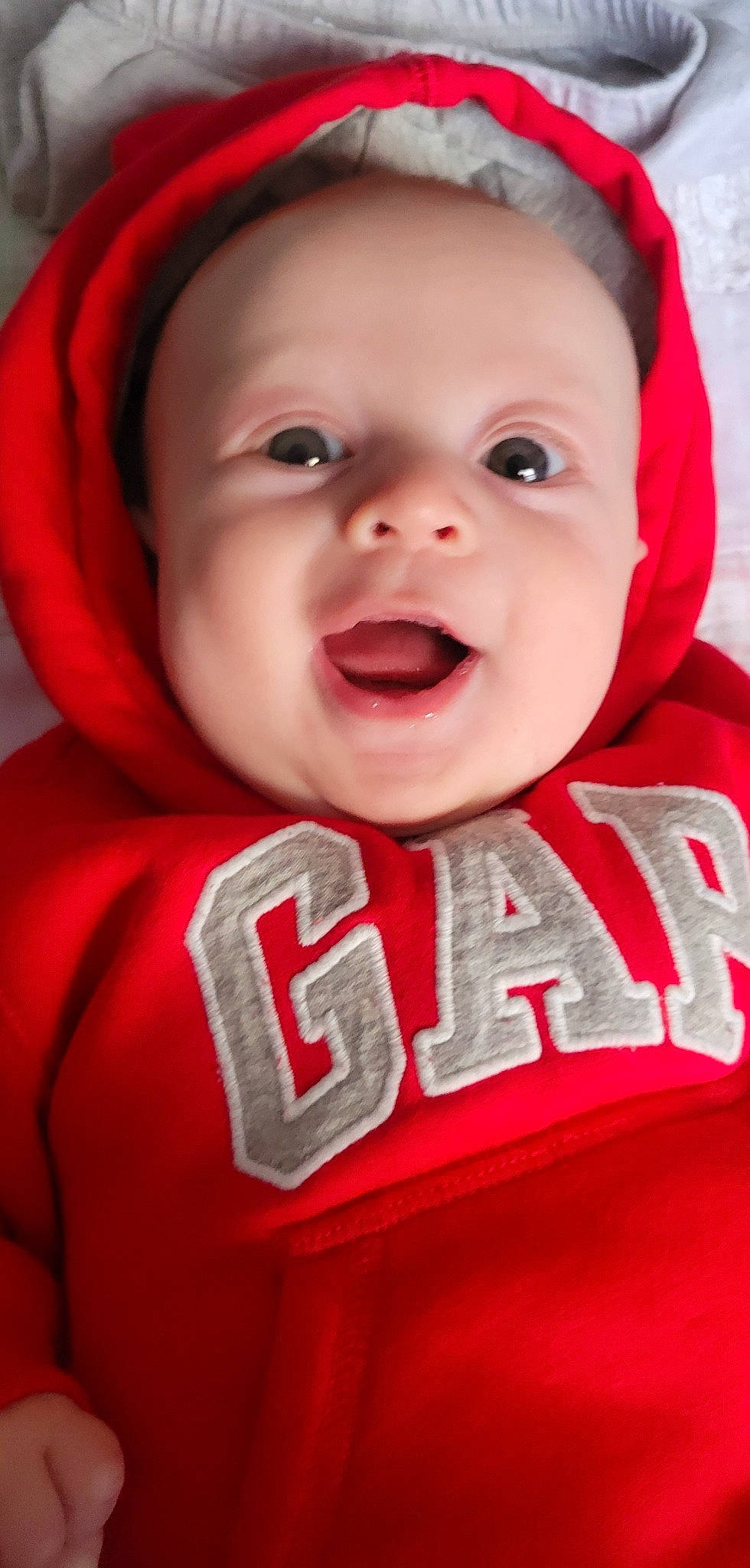 Jackson is registered to the contest to win money with this photo: baby, baby_toddler_clothing, cheek, chin, eye, eyebrow, facial_expression, happy, headgear, headwear, human_body, iris, lip, mouth, neck, nose, outerwear, person, pink, skin