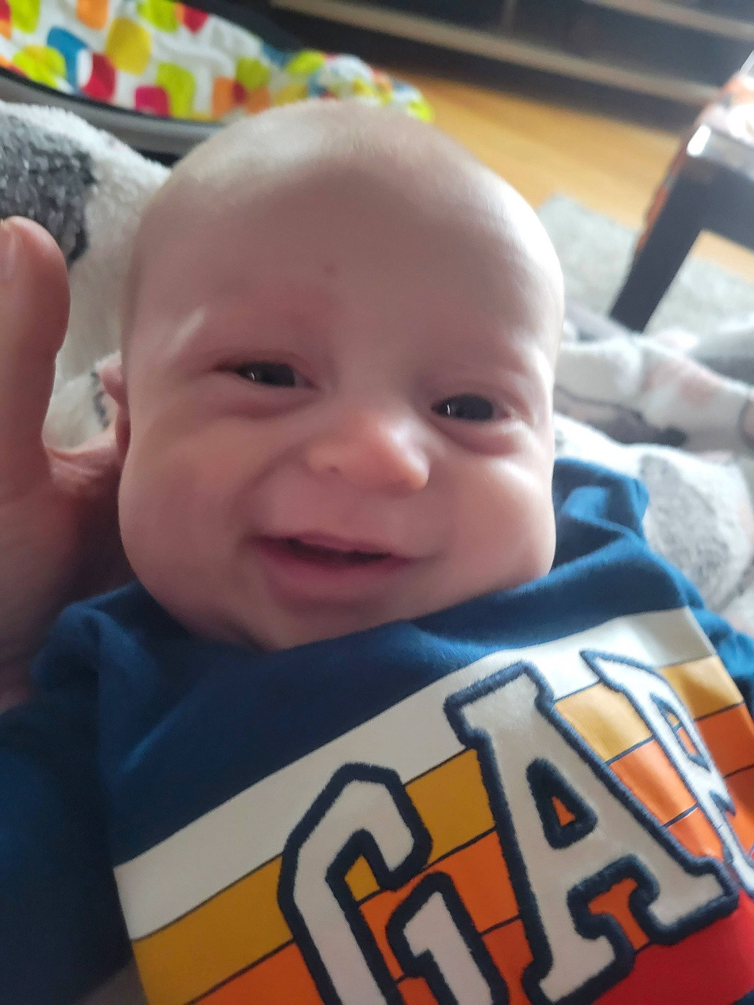 Jackson is registered to the contest to win money with this photo: baby, baby_toddler_clothing, cheek, chin, eye, eyebrow, face, facial_expression, happy, head, iris, lip, mouth, nose, person, product, skin, sleeve, smile, standing