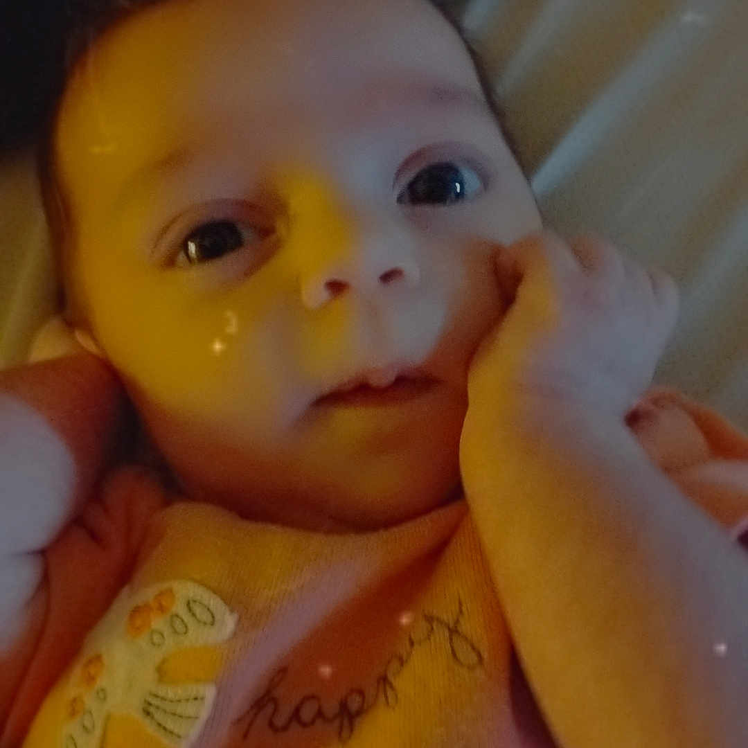 Saphira is registered to the contest to win money with this photo: baby, blanket, bodypart, clothing, crib, cutlery, face, finger, furniture, hand, happy, head, infantbed, mouth, newborn, person, photography, portrait, spoon, t_shirt