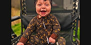 Kenley is registered to the contest to win money with this photo: baby, child, smiling, sitting, outdoor, chair, clothing, headwear, foot, cute, happy, fashion, pattern, brown, mesh, person, portrait, infant, one_person, accessory