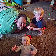 Micha joined the competition — help win amazing prizes! baby, blond_hair, bucket, carpet, carpeted_floor, casual_clothing, child, family, floor, furniture, happy, home, indoor, lying_down, man, person, playing, sitting, smiling, toys